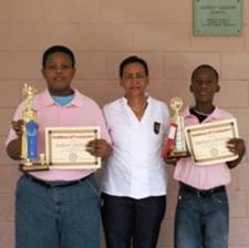 Jakeel Johnson, left and first runner-up Darwin Christian, right, flank acting Principal Joan Claxton Jakeel Johnson, left and first runner-up Darwin Christian, right, flank acting Principal Joan Claxton